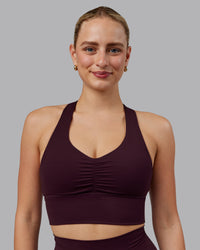 Woman wearing Evoke Sports Bra - Mulberry | Thumbnail Index: 1