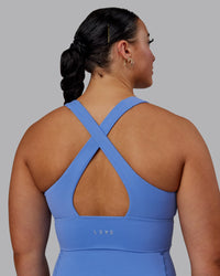 Woman wearing Evoke Sports Bra - Ultramarine | Thumbnail Index: 1