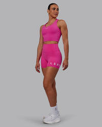 Woman wearing Evolved Ultra High-Rise 4" Short - Fuchsia Pink-White | Thumbnail Index: 4