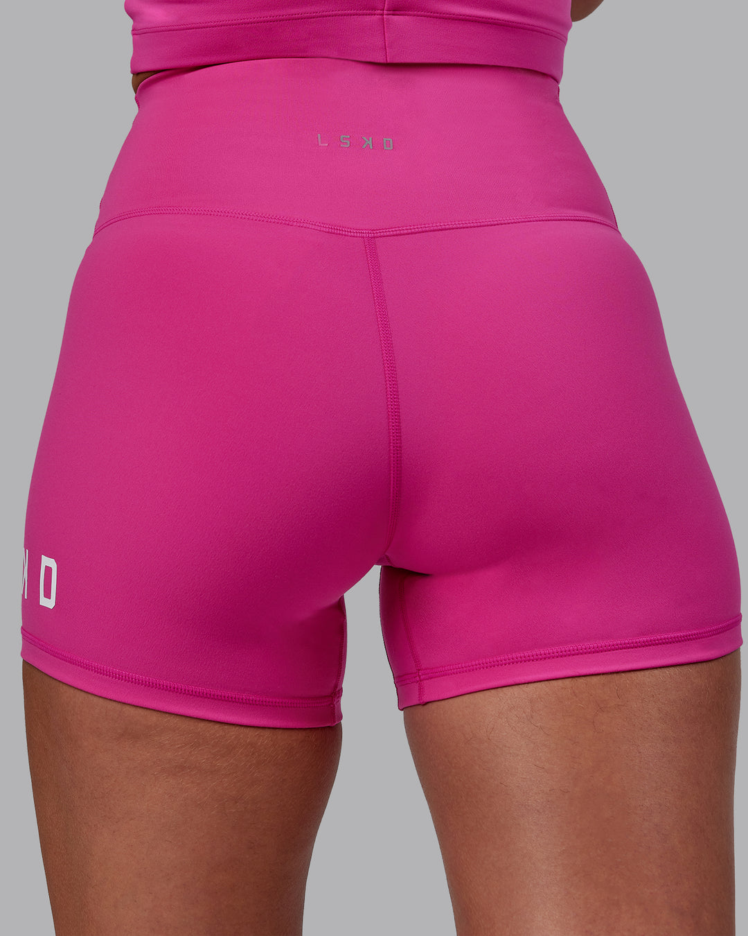 Woman wearing Evolved Ultra High-Rise 4" Short - Fuchsia Pink-White - view 7