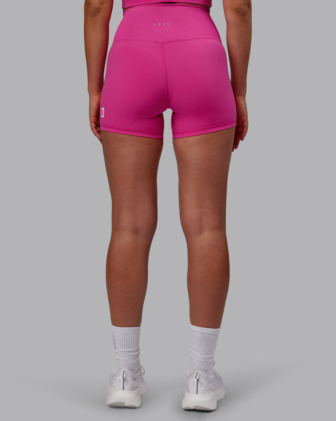 Woman wearing Evolved Ultra High-Rise 4" Short - Fuchsia Pink-White - view 4