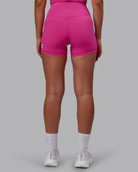 Woman wearing Evolved Ultra High-Rise 4" Short - Fuchsia Pink-White | Thumbnail Index: 3