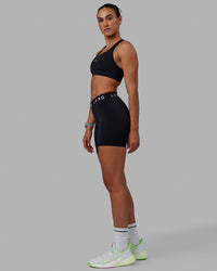 Woman wearing Extend Mid-Rise 6" Short - Black-White | Thumbnail Index: 7