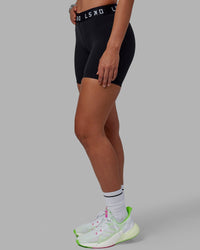 Woman wearing Extend Mid-Rise 6" Short - Black-White | Thumbnail Index: 8