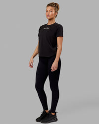 Woman wearing Fitstop Fast Tee - Black | Thumbnail Index: 2