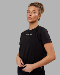 Woman wearing Fitstop Fast Tee - Black | Thumbnail Index: 0