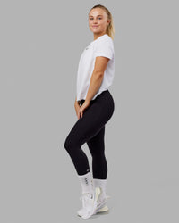 Woman wearing Fitstop Fast Tee - White | Thumbnail Index: 2