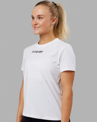 Woman wearing Fitstop Fast Tee - White | Thumbnail Index: 0