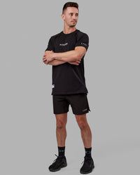 Man wearing Fitstop Optimal Tee - Black | Thumbnail Index: 2