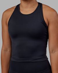 Woman wearing Flow Performance Tank - Black | Thumbnail Index: 0