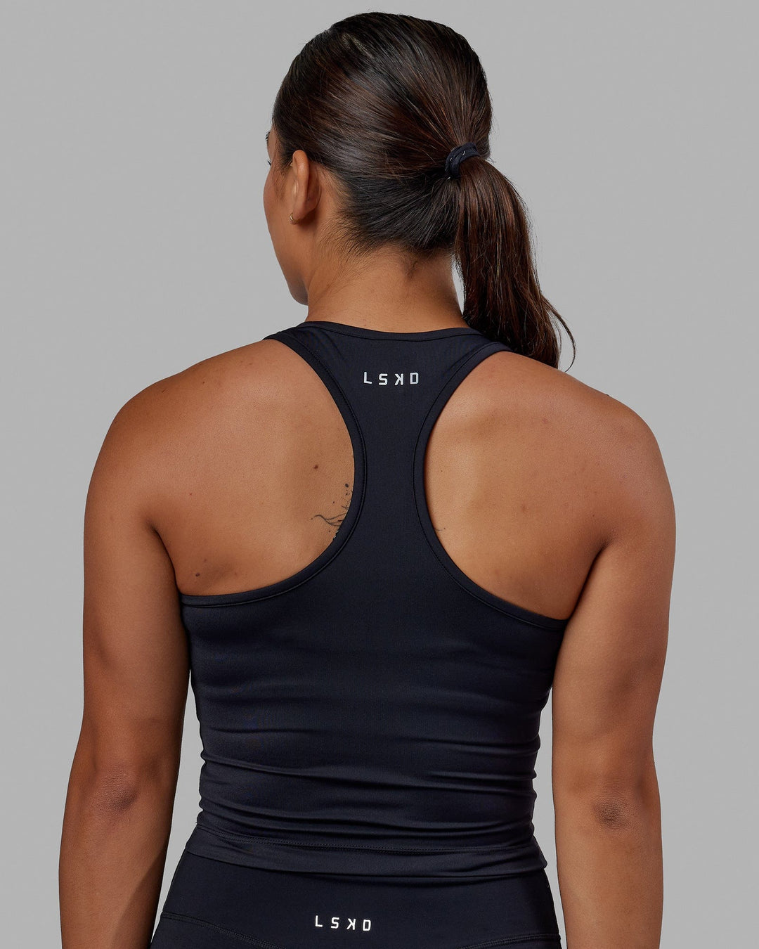 Woman wearing Flow Performance Tank - Black - view 3