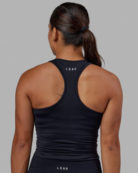 Woman wearing Flow Performance Tank - Black | Thumbnail Index: 2