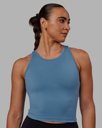 Woman wearing Flow Performance Tank - Elemental Blue | Thumbnail Index: 1