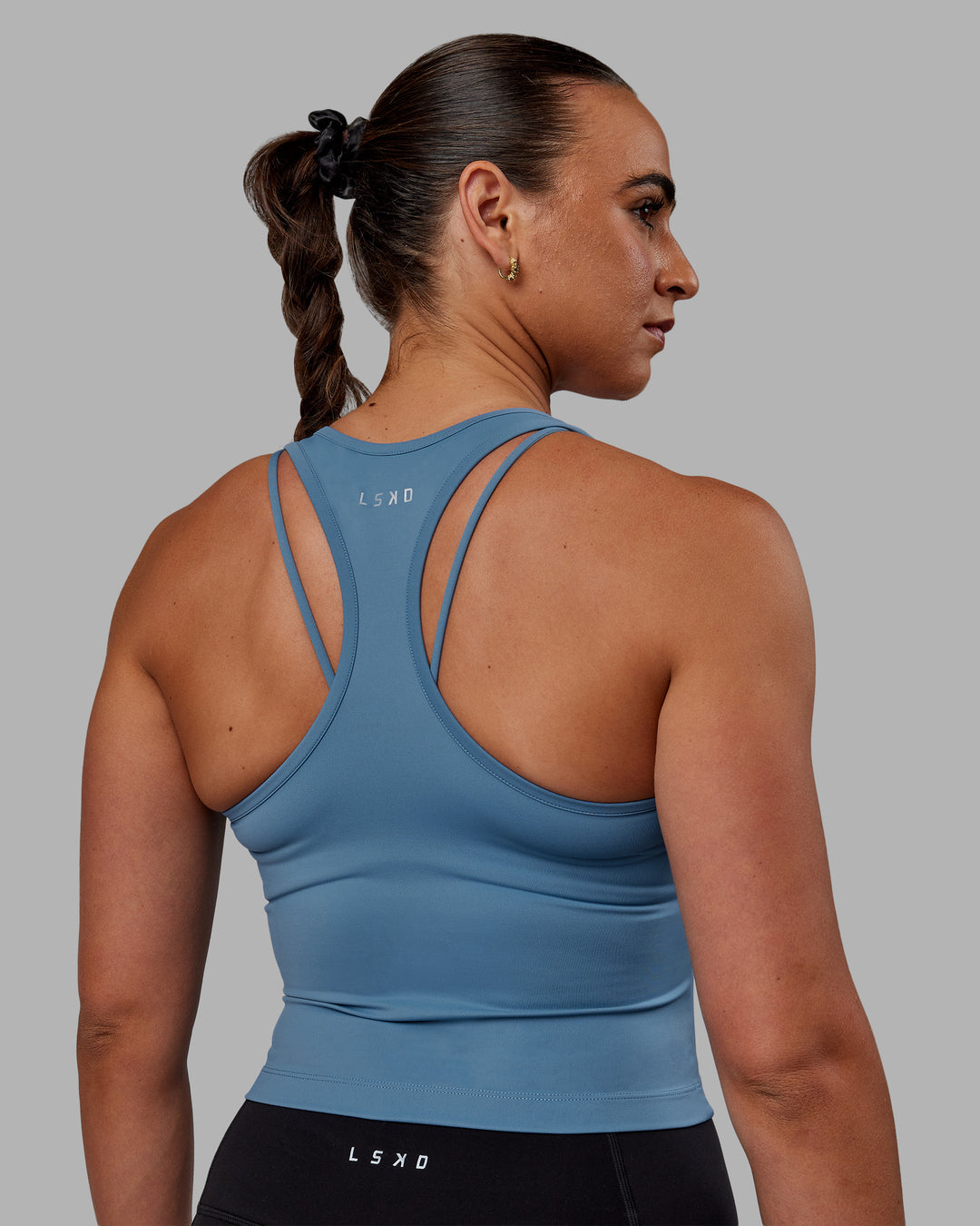 Woman wearing Flow Performance Tank - Elemental Blue - view 3