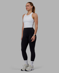 Woman wearing Flow Performance Tank - White | Thumbnail Index: 2