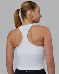 Woman wearing Flow Performance Tank - White | Thumbnail Index: 1