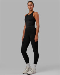 Woman wearing Flow Shelf Bra Performance Tank - Black | Thumbnail Index: 0