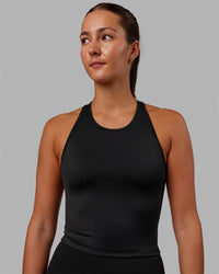 Woman wearing Flow Shelf Bra Performance Tank - Black | Thumbnail Index: 2
