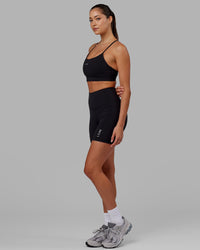 Woman wearing Flux Ultra High-Rise 6" Short Pockets - Black | Thumbnail Index: 2