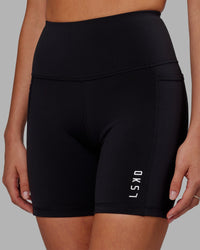 Woman wearing Flux Ultra High-Rise 6" Short Pockets - Black | Thumbnail Index: 0