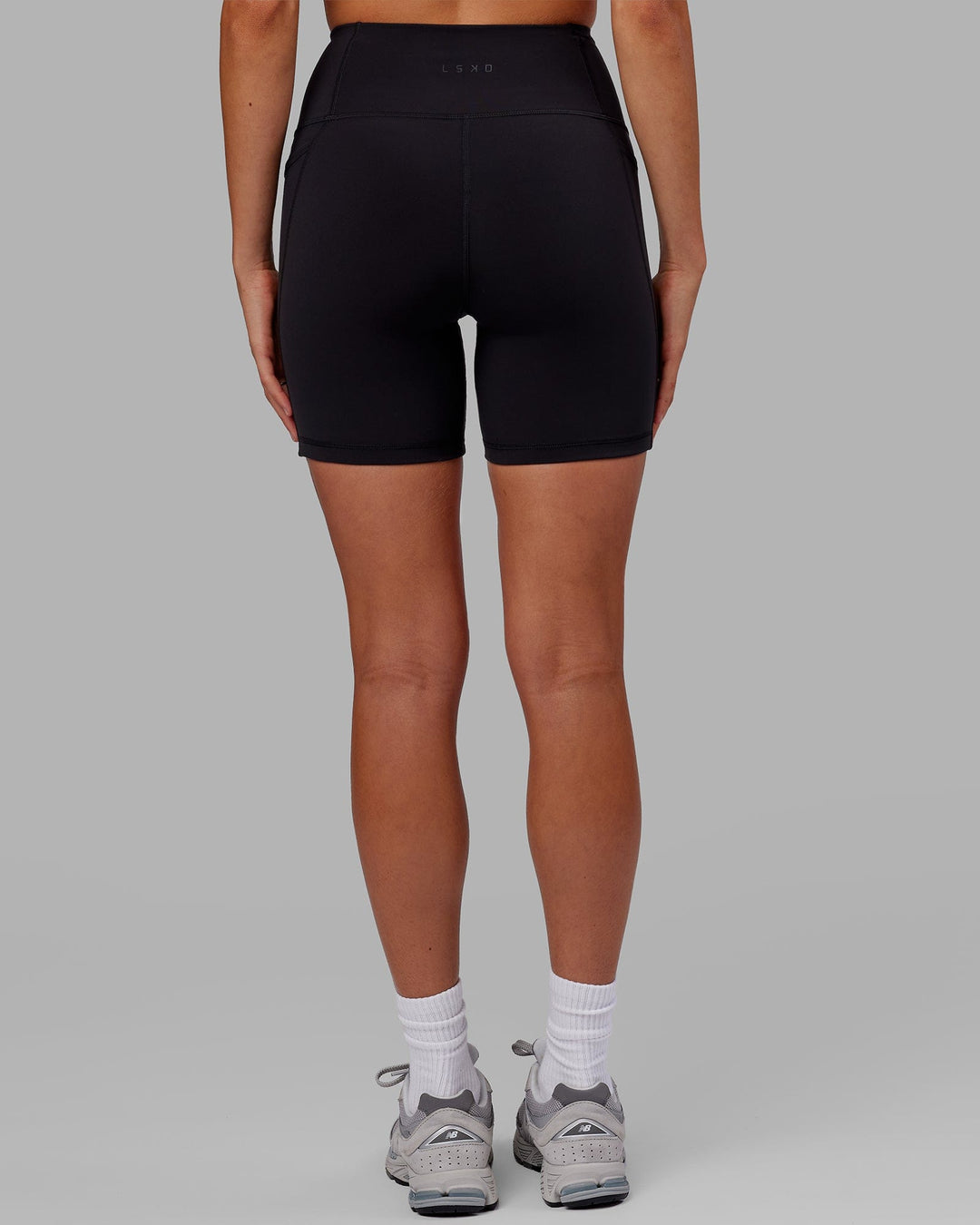 Woman wearing Flux Ultra High-Rise 6" Short Pockets - Black - view 4
