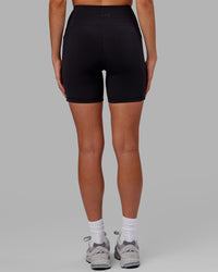 Woman wearing Flux Ultra High-Rise 6" Short Pockets - Black | Thumbnail Index: 3