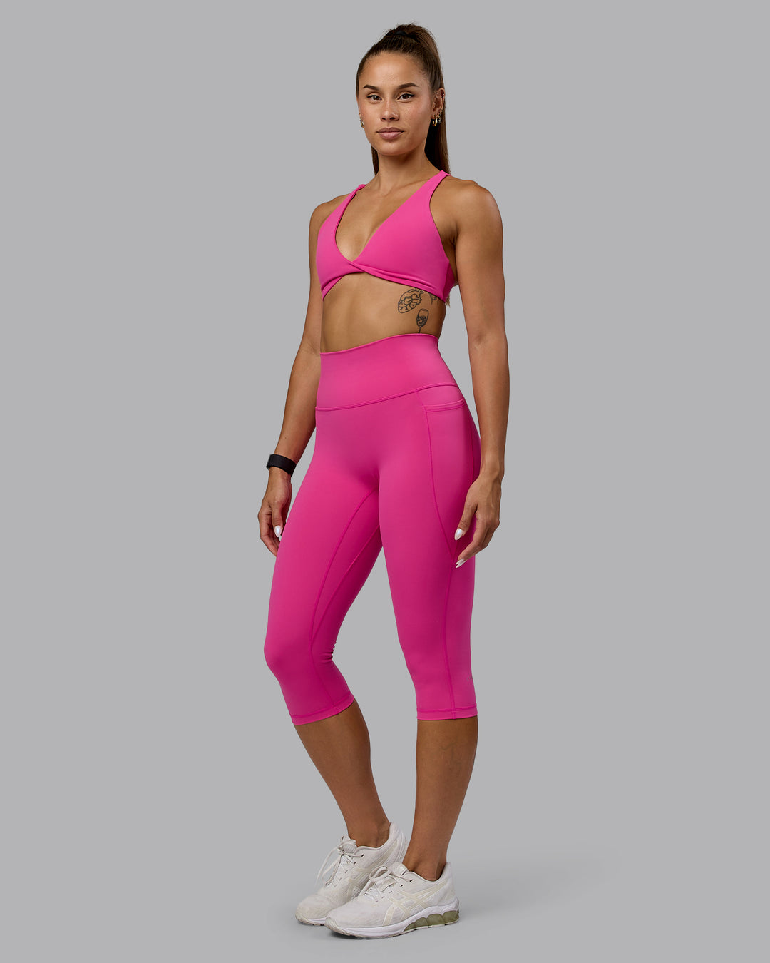Woman wearing Fusion Ultra High-Rise 3/4 Legging Pockets - Fuchsia Pink | Model:Vanessa | Size:S - view 1