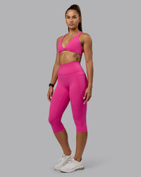 Woman wearing Fusion Ultra High-Rise 3/4 Legging Pockets - Fuchsia Pink | Model:Vanessa | Size:S | Thumbnail Index: 0