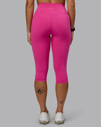 Woman wearing Fusion Ultra High-Rise 3/4 Legging Pockets - Fuchsia Pink | Model:Vanessa | Size:S | Thumbnail Index: 2