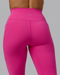 Woman wearing Fusion Ultra High-Rise 3/4 Legging Pockets - Fuchsia Pink | Model:Vanessa | Size:S | Thumbnail Index: 6