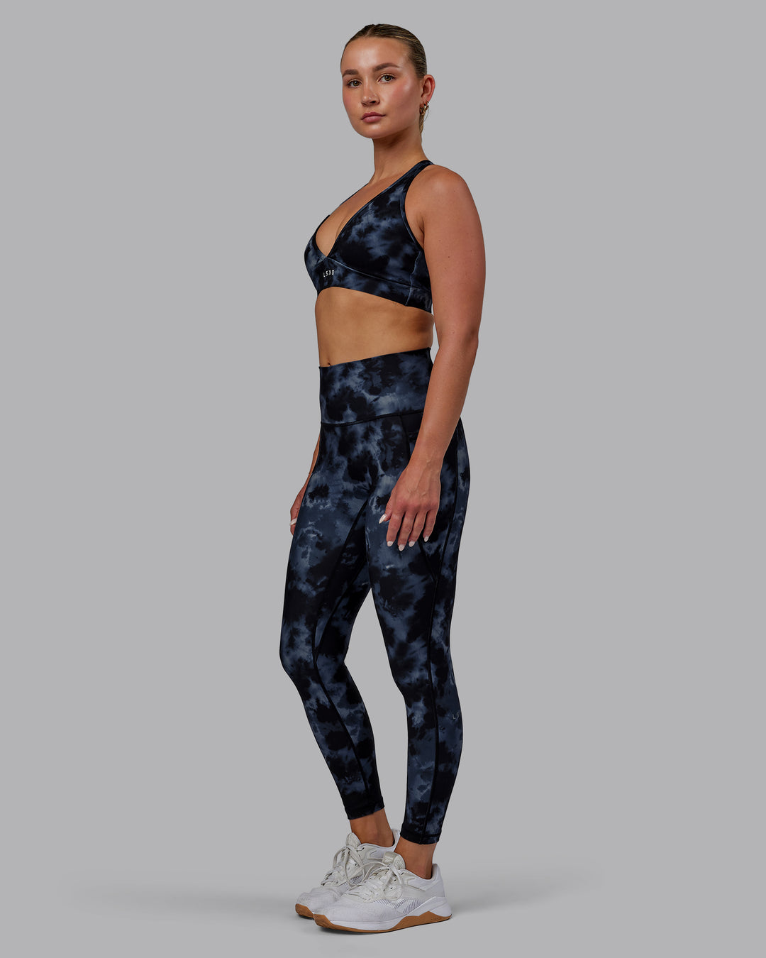 Woman wearing Fusion Ultra High-Rise 7/8 Legging Pockets - Tie Dye-Midnight | Model:Halle | Size:S - view 1