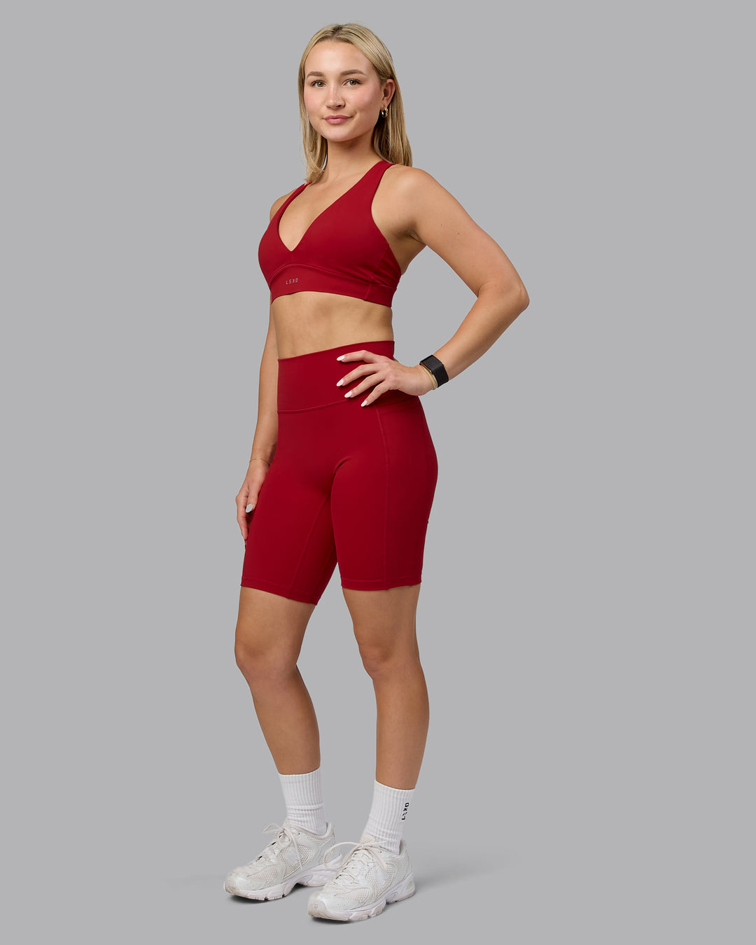 Woman wearing Fusion Ultra High-Rise 9" Short Pockets - Cherry Red | Model:Halle | Size:S - view 1