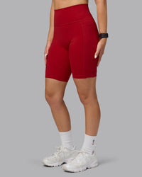 Woman wearing Fusion Ultra High-Rise 9" Short Pockets - Cherry Red | Model:Halle | Size:S | Thumbnail Index: 1