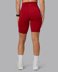 Woman wearing Fusion Ultra High-Rise 9" Short Pockets - Cherry Red | Model:Halle | Size:S | Thumbnail Index: 2