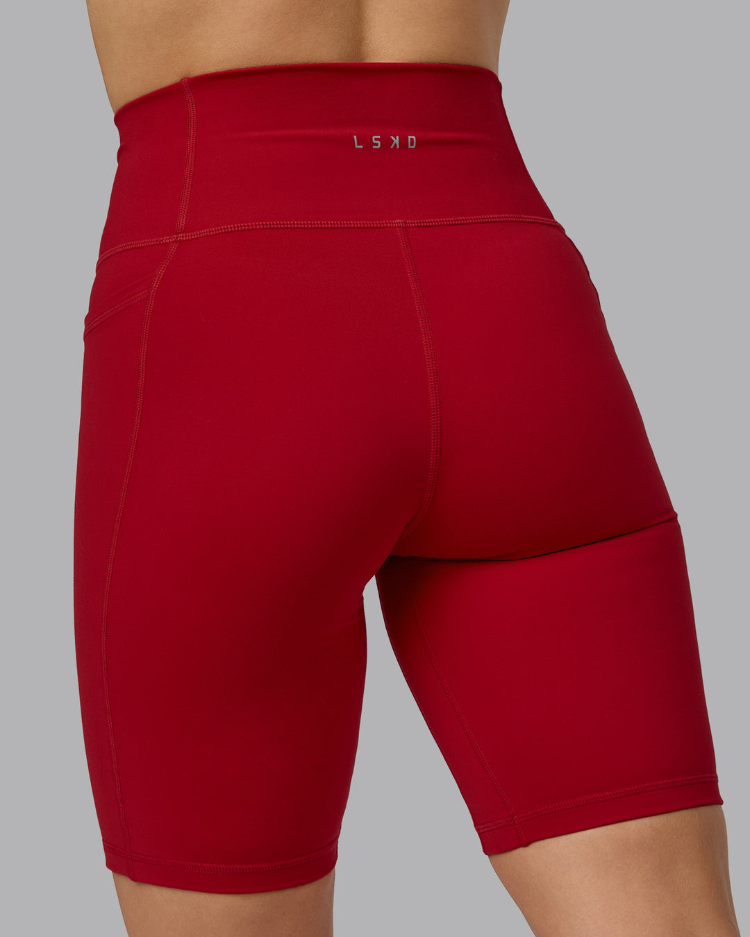 Woman wearing Fusion Ultra High-Rise 9" Short Pockets - Cherry Red | Model:Halle | Size:S - view 7