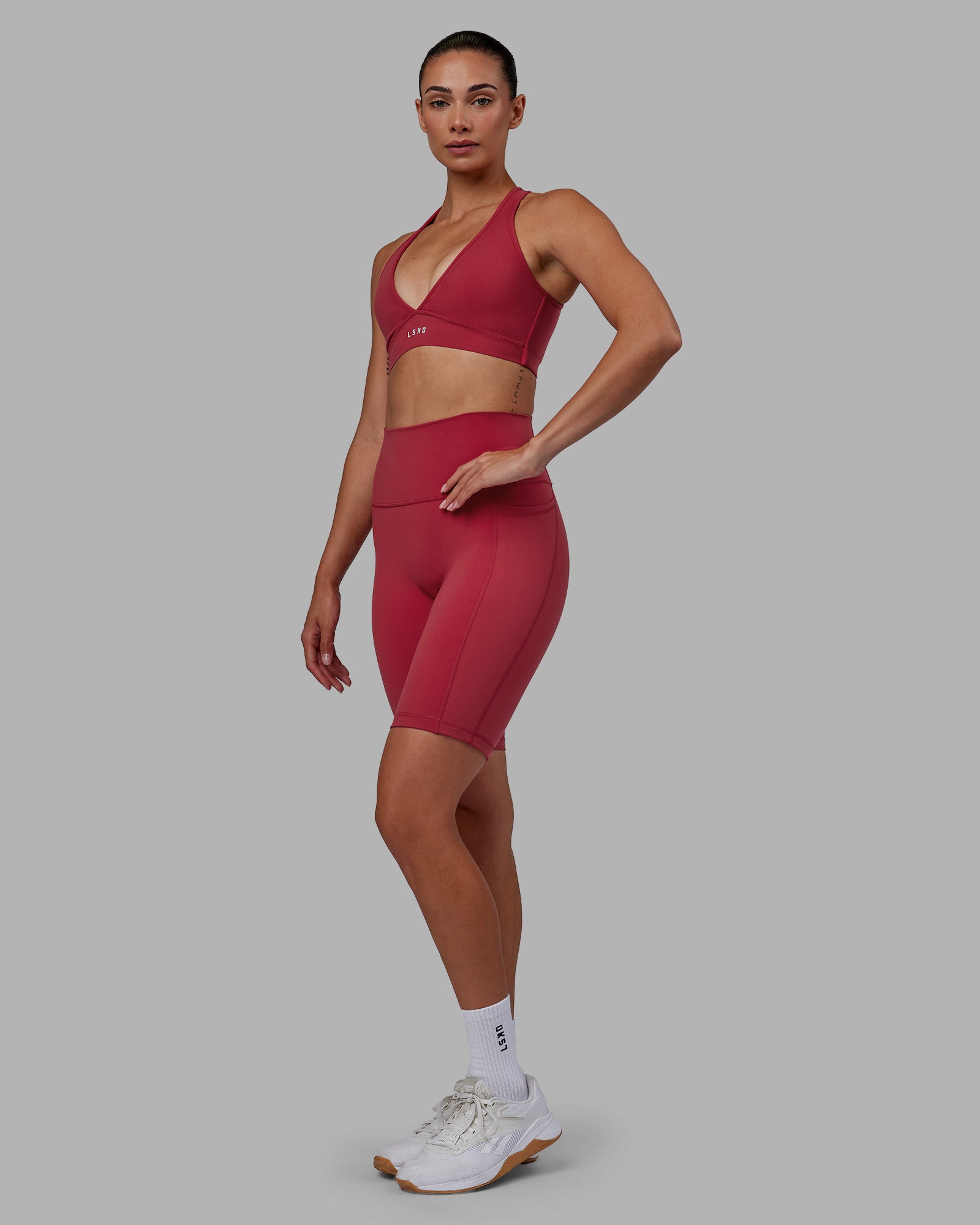 Woman wearing Fusion Ultra High-Rise 9" Short Pockets - Claret | Model:Blaize | Size:S
