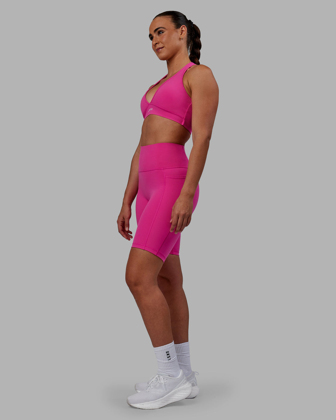 Woman wearing Fusion Ultra High-Rise 9" Short Pockets - Fuchsia Pink | Model:Sophie | Size:S - view 7