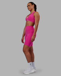 Woman wearing Fusion Ultra High-Rise 9" Short Pockets - Fuchsia Pink | Model:Sophie | Size:S | Thumbnail Index: 6