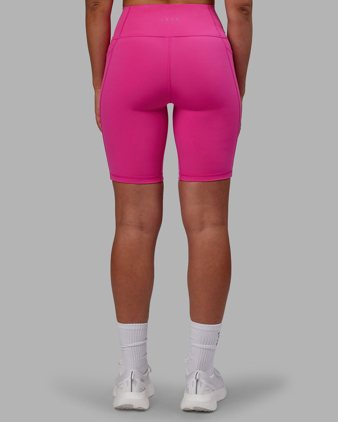 Woman wearing Fusion Ultra High-Rise 9" Short Pockets - Fuchsia Pink | Model:Sophie | Size:S - view 3