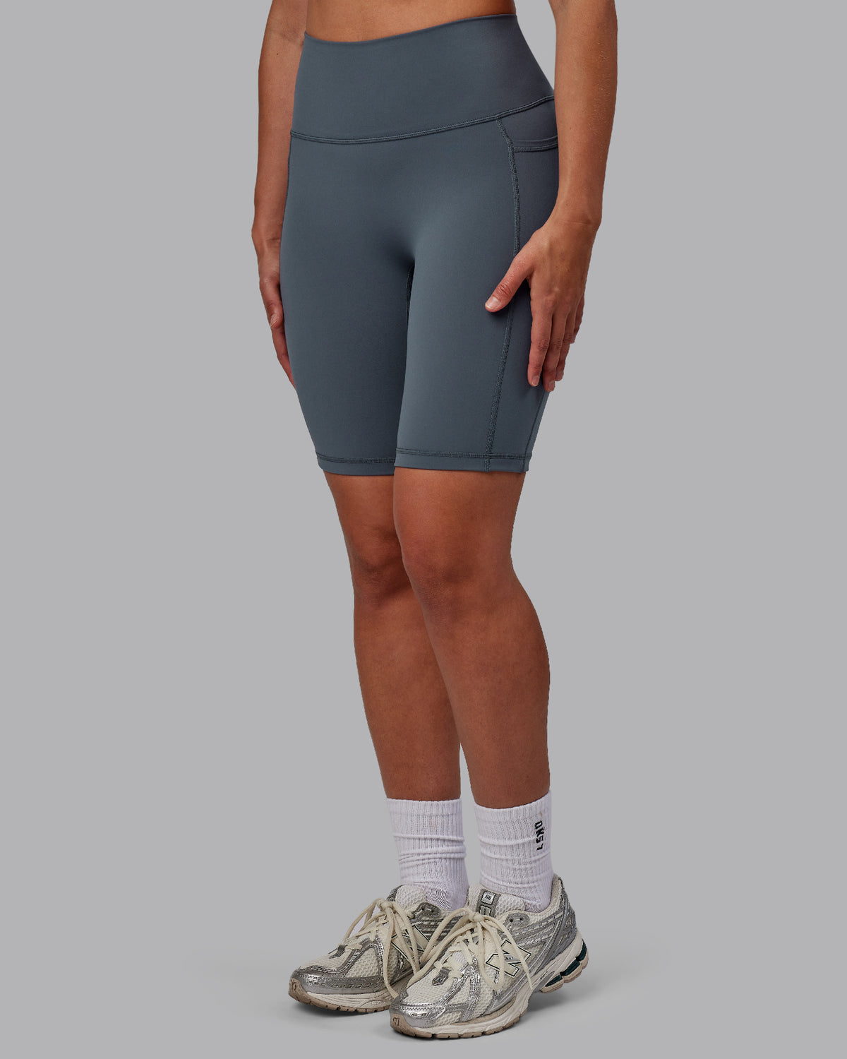 Woman wearing Fusion Ultra High-Rise 9" Short Pockets - Turbulence | Model:Sophie | Size:S