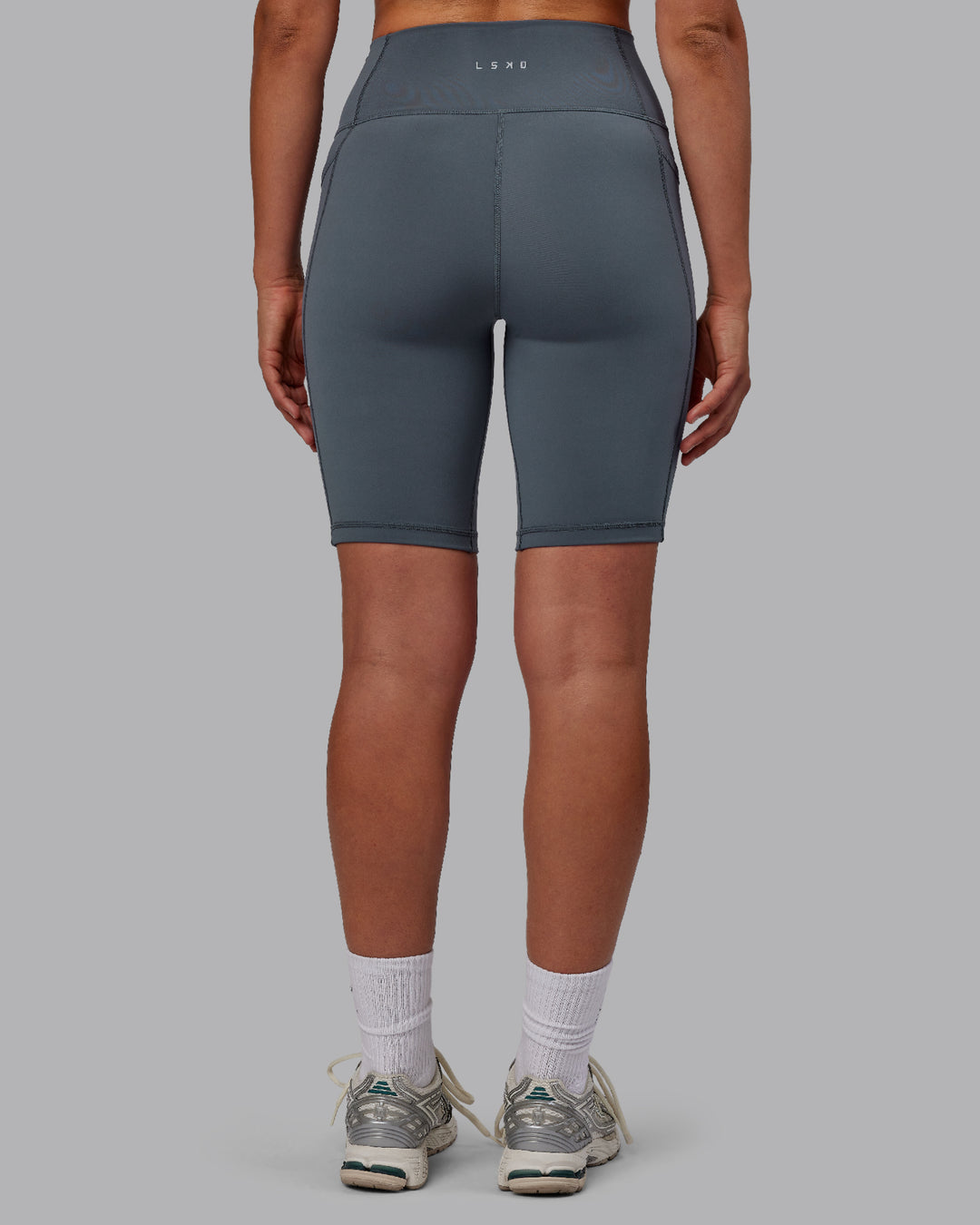 Woman wearing Fusion Ultra High-Rise 9" Short Pockets - Turbulence | Model:Sophie | Size:S - view 3
