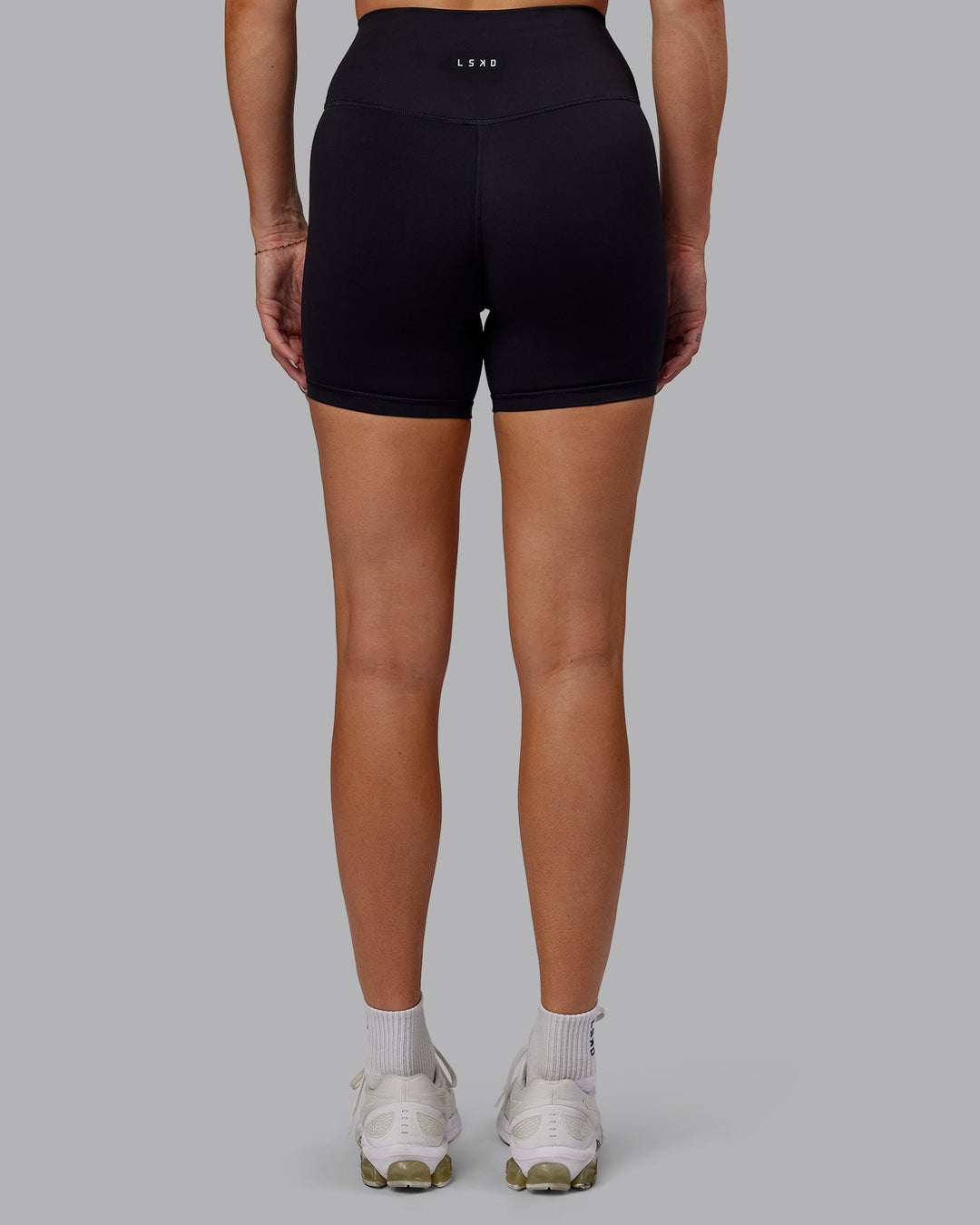 Woman wearing Fusion Ultra High-Rise 6" Short - Black | Set:true | Angle:back | Model:Hannah | Size:S - view 4