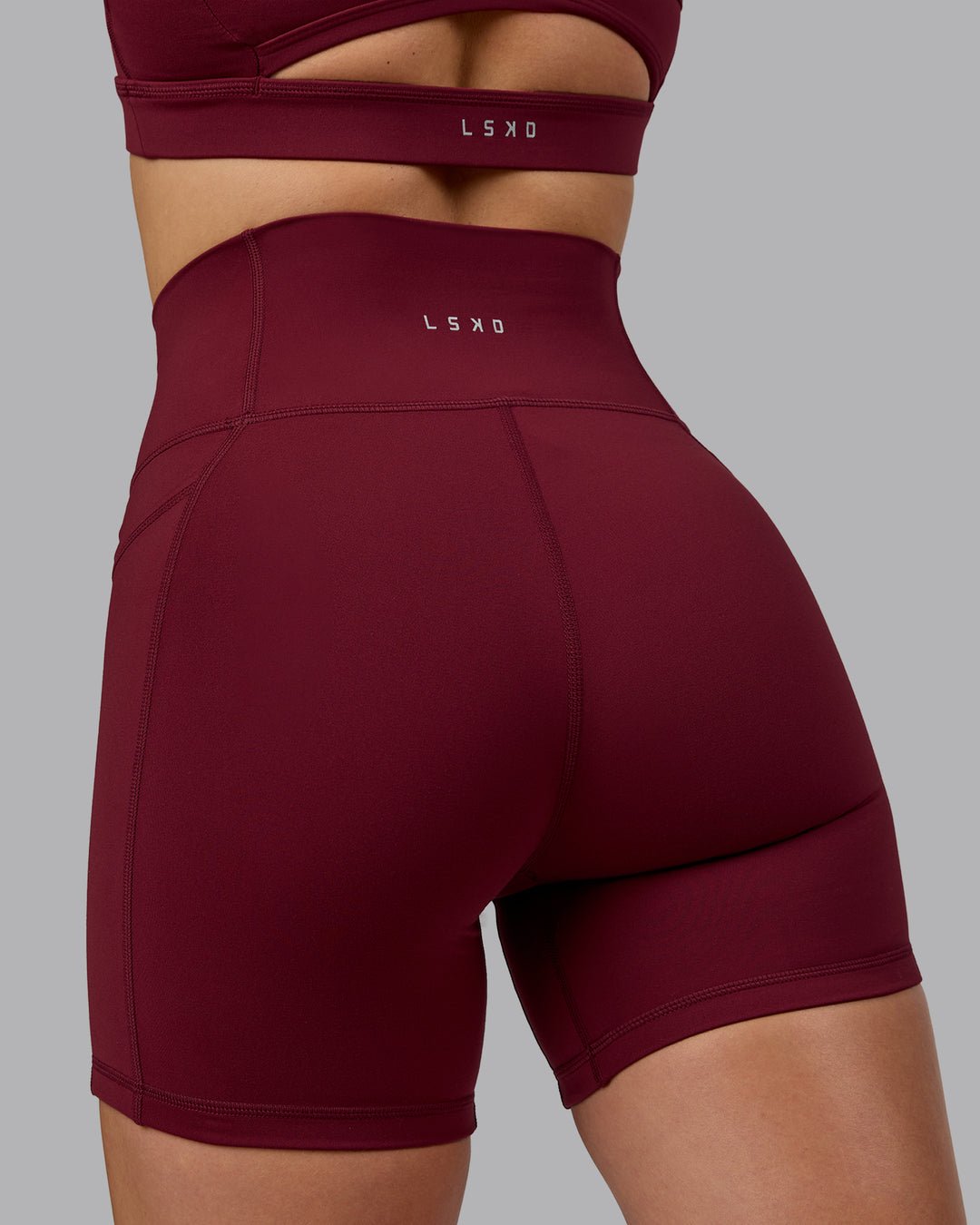 Woman wearing Fusion Ultra High-Rise 6" Short Pockets - Cordovan | Model:Chloe | Size:XS - view 3