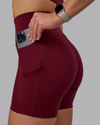 Woman wearing Fusion Ultra High-Rise 6" Short Pockets - Cordovan | Model:Chloe | Size:XS | Thumbnail Index: 1