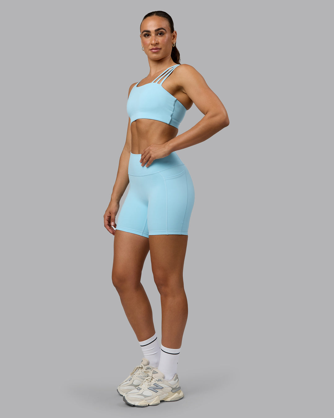 Woman wearing Fusion Ultra High-Rise 6" Short Pockets - Crystal Blue | Model:Sophie | Size:S - view 2
