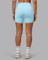 Woman wearing Fusion Ultra High-Rise 6" Short Pockets - Crystal Blue | Set:true | Angle:back | Model:Sophie | Size:S | Thumbnail Index: 2