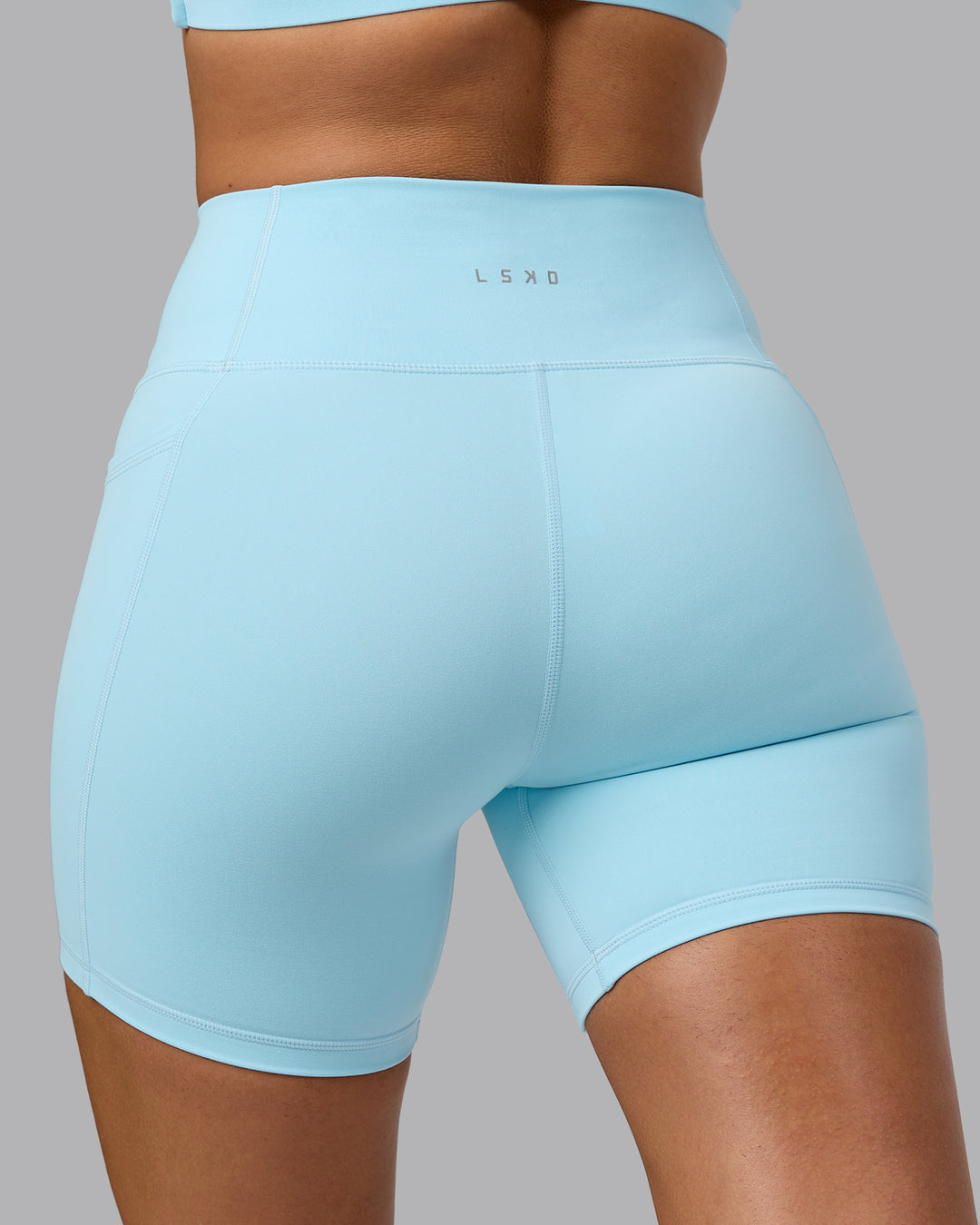 Woman wearing Fusion Ultra High-Rise 6" Short Pockets - Crystal Blue | Model:Sophie | Size:S - view 7