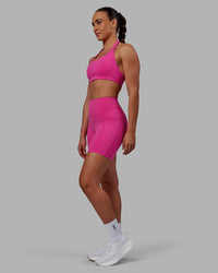 Woman wearing Fusion Ultra High-Rise 6" Short Pockets - Fuchsia Pink | Model:Sophie | Size:S | Thumbnail Index: 1
