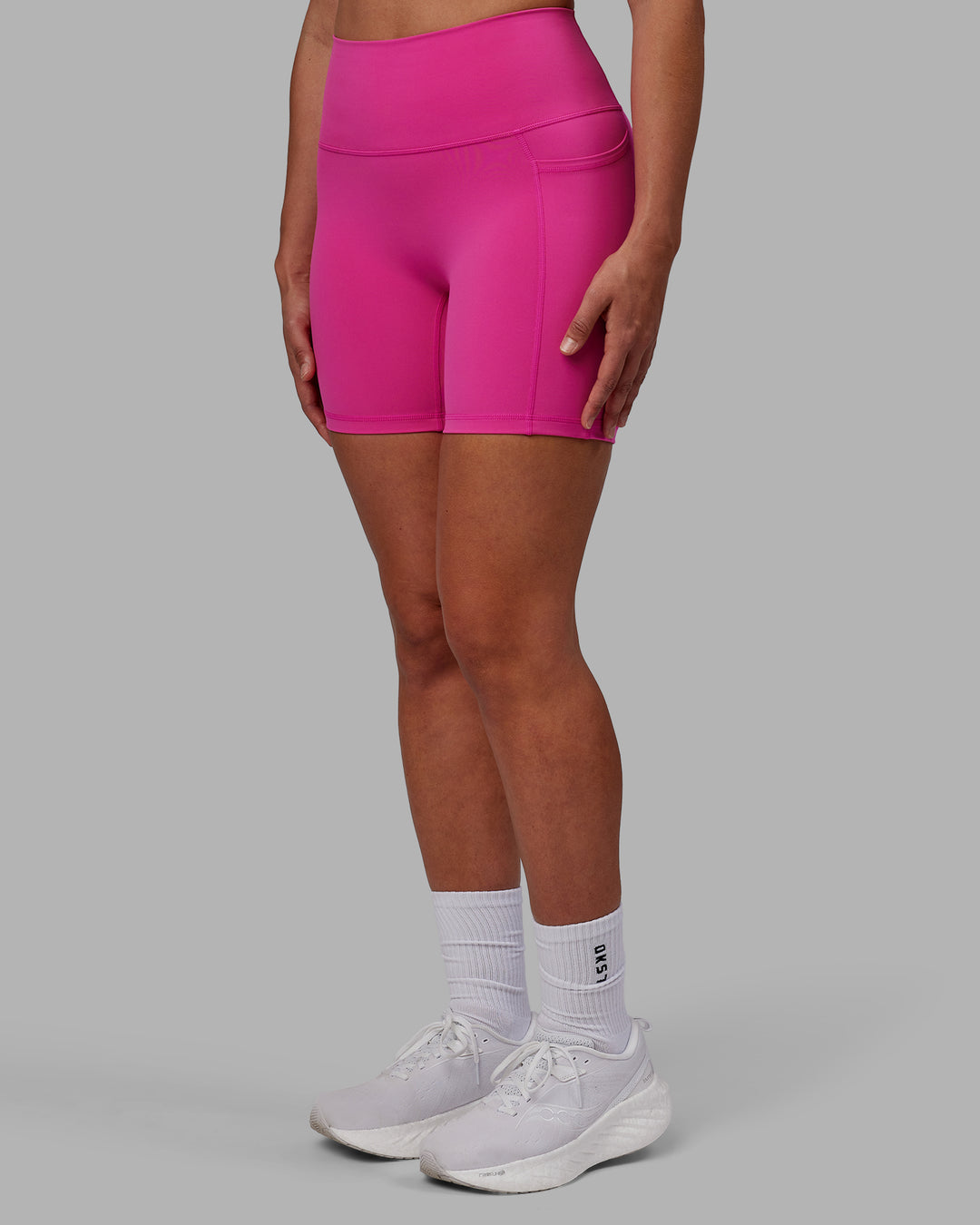 Woman wearing Fusion Ultra High-Rise 6" Short Pockets - Fuchsia Pink | Set:true | Angle:side | Model:Sophie | Size:S - view 1