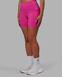 Woman wearing Fusion Ultra High-Rise 6" Short Pockets - Fuchsia Pink | Set:true | Angle:side | Model:Sophie | Size:S | Thumbnail Index: 0